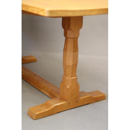 816 - DAVID LANGSTAFF, AN ADZED OAK DINING TABLE, the rounded oblong top on turned faceted end supports, t... 