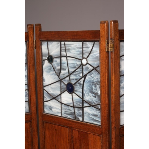 824 - AN OAK THREE FOLD PANELLED ROOM SCREEN, c.1900, each fold with upper leaded glazed opaque and colour... 