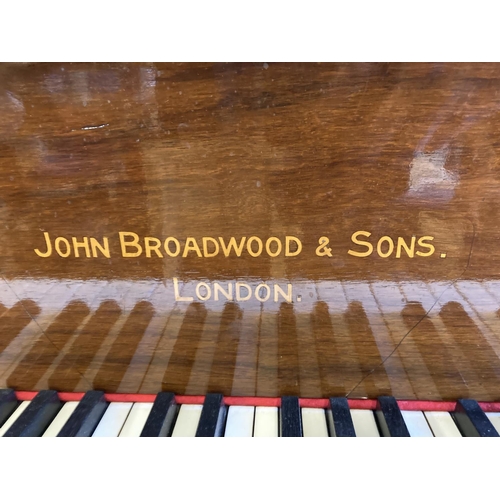 834 - A JOHN BROADWOOD & SONS BABY GRAND PIANO in mahogany case with Chinese fret music stand, raised on s... 