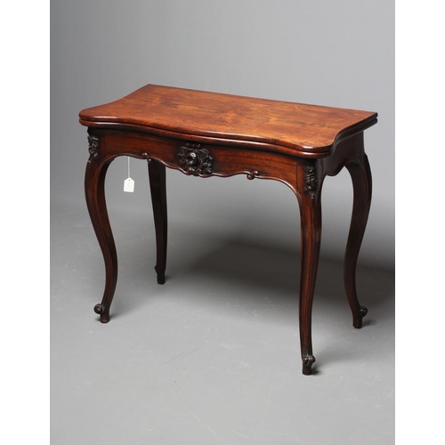 862 - A VICTORIAN ROSEWOOD FOLDING CARD TABLE of serpentine oblong form, the swivel top opening to interio... 