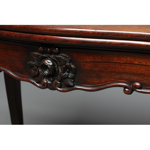 862 - A VICTORIAN ROSEWOOD FOLDING CARD TABLE of serpentine oblong form, the swivel top opening to interio... 