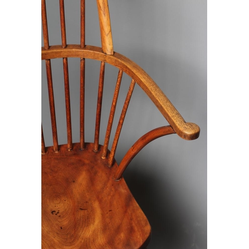 872 - A HIGH HOOP BACK WINDSOR ARMCHAIR, late 19th century (?), in beech, ash and elm, with spindle back, ... 