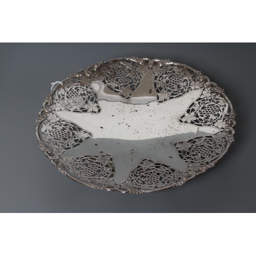 100 - A SILVER CENTRE DISH, maker Frank Cobb & Co., Sheffield 1955, of lobed circular form with fruiting v... 