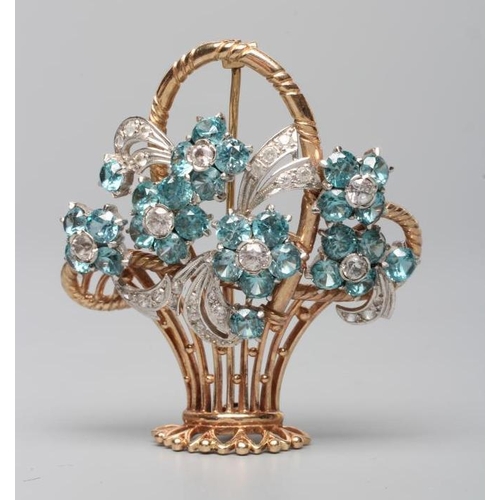 174 - A TOPAZ AND DIAMOND FLOWER BASKET BROOCH, the six claw set blue topaz flower heads all centred by ro... 