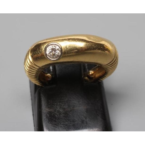 181 - AN UNUSUAL DIAMOND RING, the plain wide panel offset with a collet set with a round brilliant cut st... 