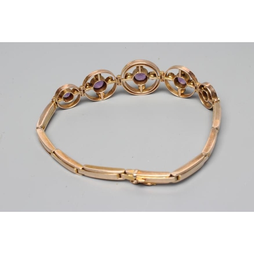 188 - AN EDWARDIAN AMETHYST AND SEED PEARL BRACELET, the five graduated open circlets each centred by a co... 