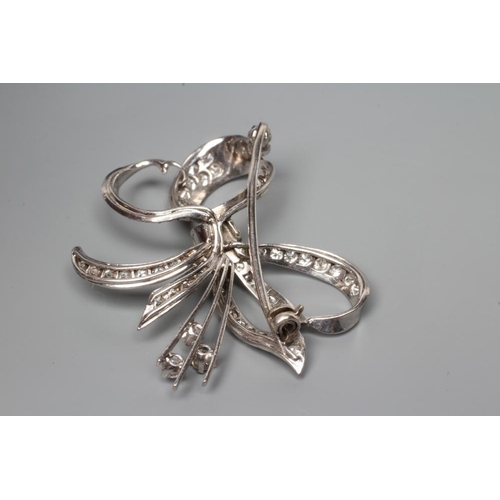 192 - A DIAMOND BOW BROOCH, the white unmarked metal frame pave set with numerous round cut stones (Est. p... 