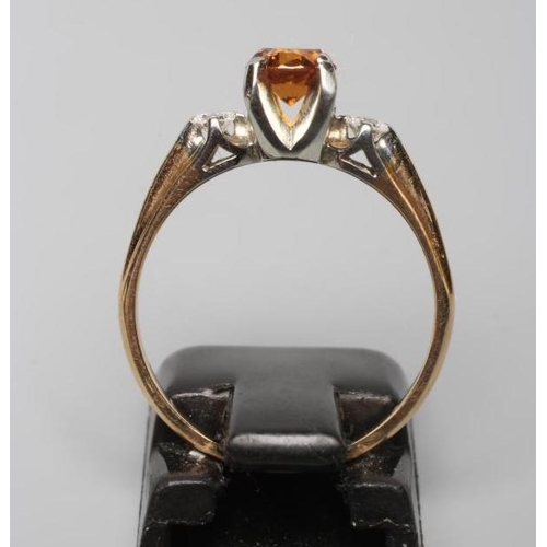 193 - AN ORANGE SAPPHIRE AND DIAMOND THREE STONE RING, the round facet cut sapphire claw set and flanked b... 