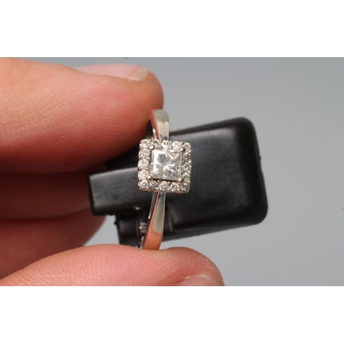 202 - A DIAMOND CLUSTER RING, the central square cut stone claw set to an open border of sixteen small rou... 