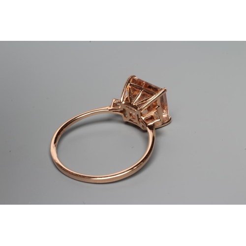 217 - A MORGANITE DRESS RING, the Asscher cut stone claw set and with two small baguette cut stones to eac... 