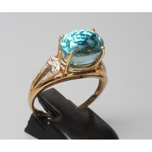 221 - A BLUE TOPAZ COCKTAIL RING, the oval facet cut stone horizontally claw set to open bead shoulders po... 