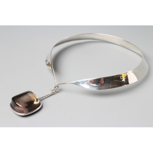 233 - A GEORG JENSEN SILVER NECK RING designed by Vivianna Torun Bulow-Hube, with tension clamp and hung w... 