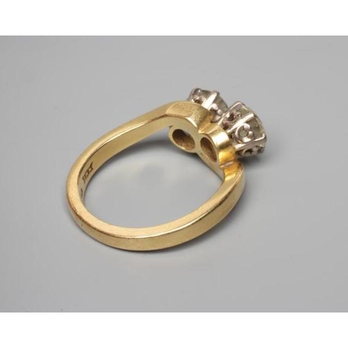 239 - A TWO STONE CROSSOVER DIAMOND RING, the old brilliant cut stones each of approximately 0.50cts, claw... 