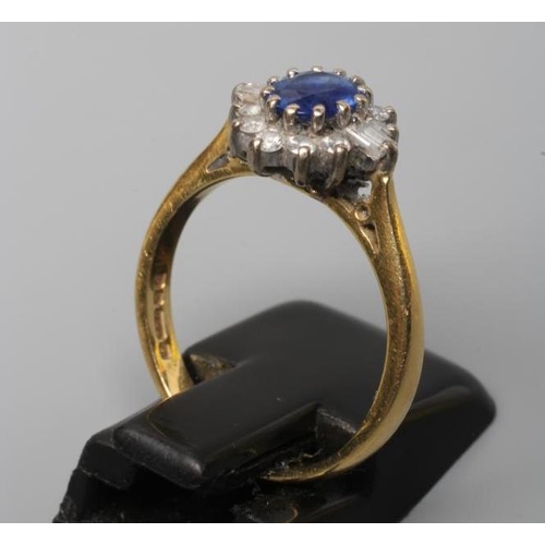 240 - A SAPPHIRE AND DIAMOND CLUSTER RING, the oval facet cut sapphire claw set to a border of ten small r... 