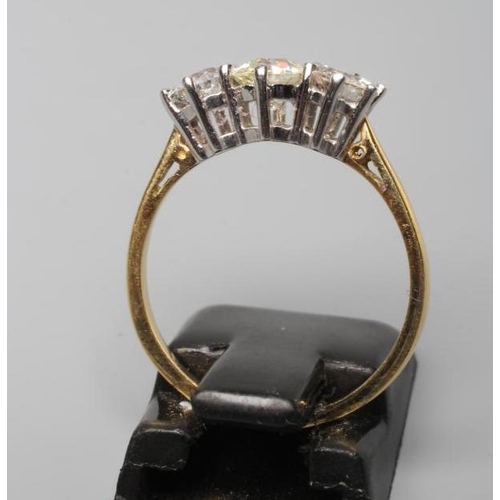 246 - A THREE STONE DIAMOND RING, the central old cut stone flanked by two similar smaller stones totallin... 