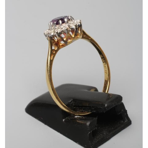 255 - AN AMETHYST AND DIAMOND CLUSTER RING, the oval facet cut amethyst claw set to a border of small diam... 