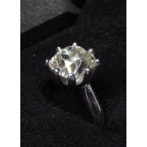 259 - A SOLITAIRE DIAMOND RING, the cushion cut stone of 5.19cts, claw set to a plain platinum shank, size... 