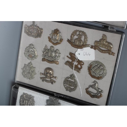 514 - THIRTY TWO BRITISH MILITARY CAP BADGES including English and Scottish regiments, in three plastic ca... 