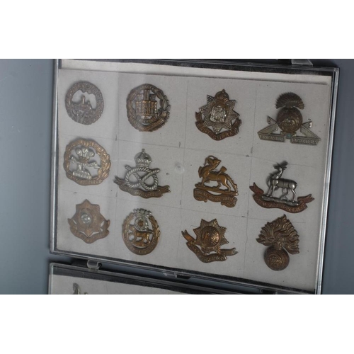 514 - THIRTY TWO BRITISH MILITARY CAP BADGES including English and Scottish regiments, in three plastic ca... 