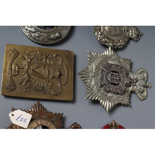 521 - A COLLECTION OF BRITISH MILITARY CAP BADGES AND PLAID BROOCHES including a Victorian Royal Irish Reg... 