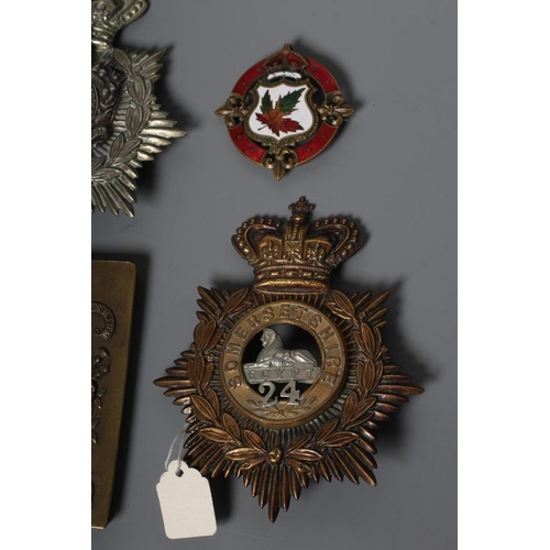 521 - A COLLECTION OF BRITISH MILITARY CAP BADGES AND PLAID BROOCHES including a Victorian Royal Irish Reg... 