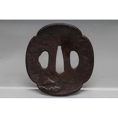 573 - A JAPANESE TSUBA, Edo period, of classic four lobed shape, pierced either side of the tang hole and ... 