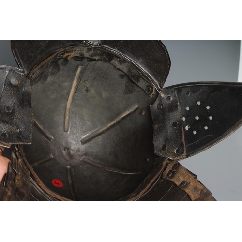 579 - A LOBSTER TAIL HELMET, part 17th century, with pointed peak, articulated neck guard, rivetted constr... 