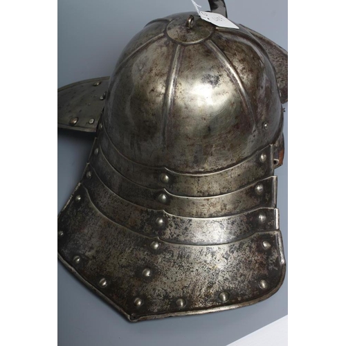 579 - A LOBSTER TAIL HELMET, part 17th century, with pointed peak, articulated neck guard, rivetted constr... 