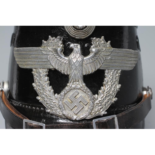 582 - A SECOND WORLD WAR GERMAN POLICE SHAKO, with large metal Third Reich eagle badge, peak, leather chin... 