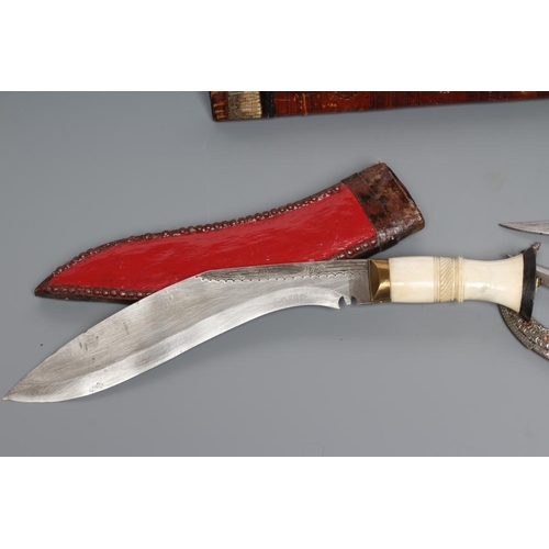 583 - FIVE DAGGERS, comprising a civilian kukri with bone handle, a Tanzanian Tribal long knife with etche... 