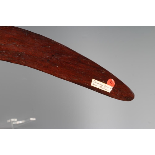 587 - AN ABORIGINAL BOOMERANG with one flat edge and long tooling marks throughout, old label inscribed 