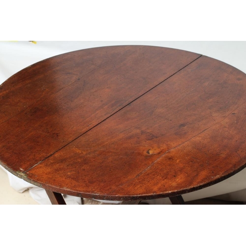 876 - A MAHOGANY CAMPAIGN TABLE, early 19th century, the circular hinged top raised on shaped square secti... 