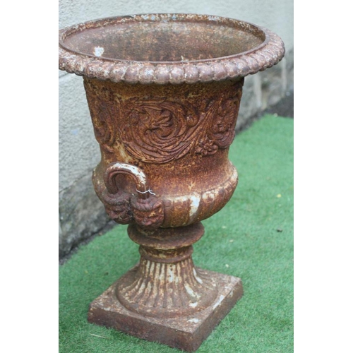 758 - A VICTORIAN CAST IRON URN of half fluted campana form with everted ovolo moulded rim and mask loop h... 