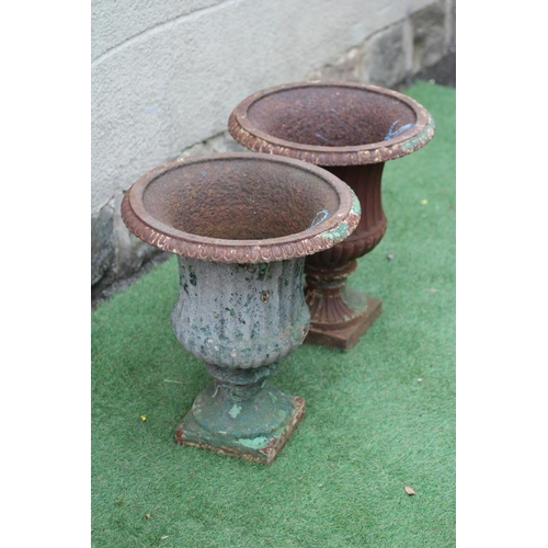 759 - A PAIR OF VICTORIAN CAST IRON URNS of half fluted campana form with everted ovolo rim, waisted socle... 