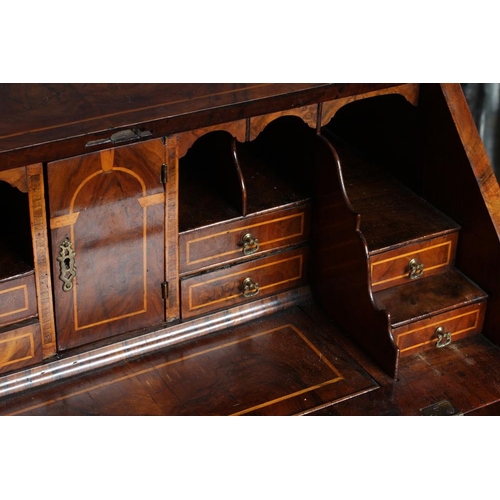 837 - A GEORGIAN WALNUT BUREAU, third quarter 18th century, the banded fallfront with stringing enclosing ... 