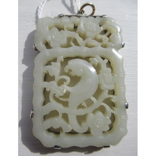 375 - A CHINESE JADE OBLONG DOUBLE SIDED PANEL, carved and pierced with a parrot type bird amidst flowerin... 