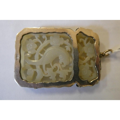 375 - A CHINESE JADE OBLONG DOUBLE SIDED PANEL, carved and pierced with a parrot type bird amidst flowerin... 