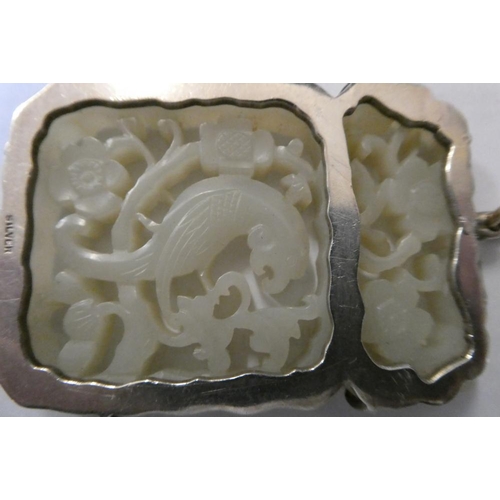 375 - A CHINESE JADE OBLONG DOUBLE SIDED PANEL, carved and pierced with a parrot type bird amidst flowerin... 