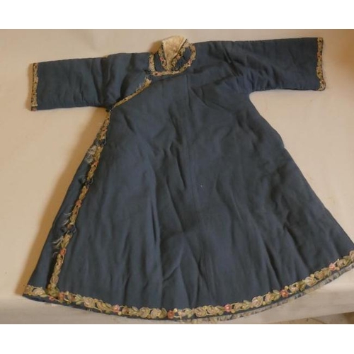 398 - A CHINESE WINTER ROBE, the plain blue woven coat with machine embroidered foliate braiding to all ed... 