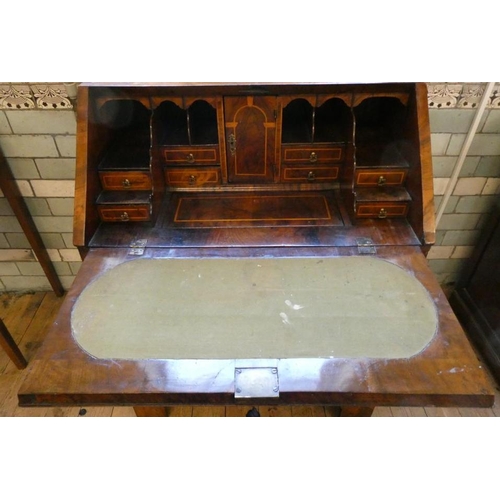 837 - A GEORGIAN WALNUT BUREAU, third quarter 18th century, the banded fallfront with stringing enclosing ... 