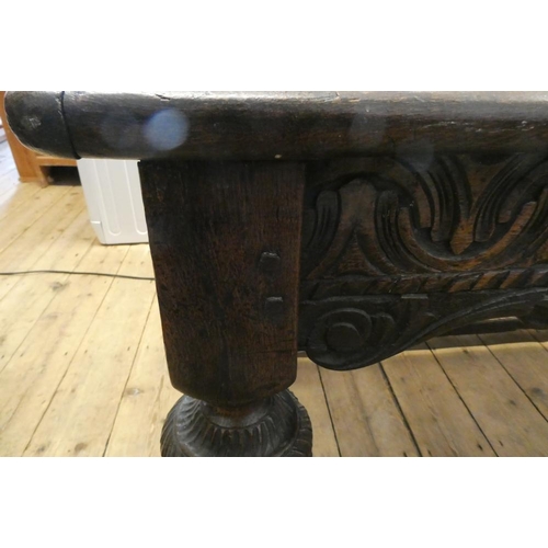 873 - A JOINED OAK DINING TABLE, 17th century and later, the cleated plank oblong top with lunette carved ... 