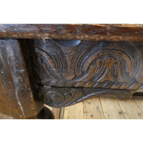 873 - A JOINED OAK DINING TABLE, 17th century and later, the cleated plank oblong top with lunette carved ... 