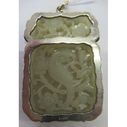 375 - A CHINESE JADE OBLONG DOUBLE SIDED PANEL, carved and pierced with a parrot type bird amidst flowerin... 