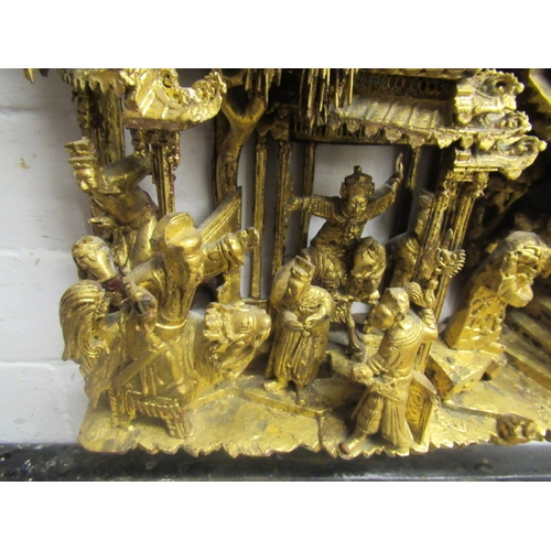 414 - A CHINESE CARVED AND PIERCED GILTWOOD PANEL, featuring a garden pavilion with noble figures flanked ... 