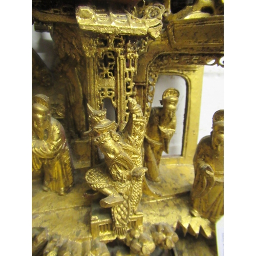 414 - A CHINESE CARVED AND PIERCED GILTWOOD PANEL, featuring a garden pavilion with noble figures flanked ... 