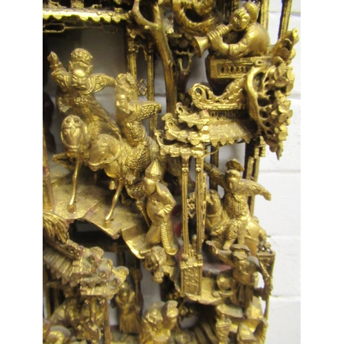 414 - A CHINESE CARVED AND PIERCED GILTWOOD PANEL, featuring a garden pavilion with noble figures flanked ... 