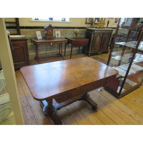 863 - AN EARLY VICTORIAN BURR OAK LIBRARY TABLE, the rounded oblong top over frieze drawer flanked on eith... 