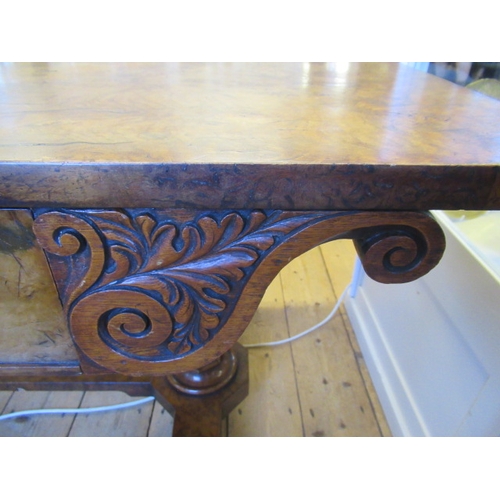 863 - AN EARLY VICTORIAN BURR OAK LIBRARY TABLE, the rounded oblong top over frieze drawer flanked on eith... 