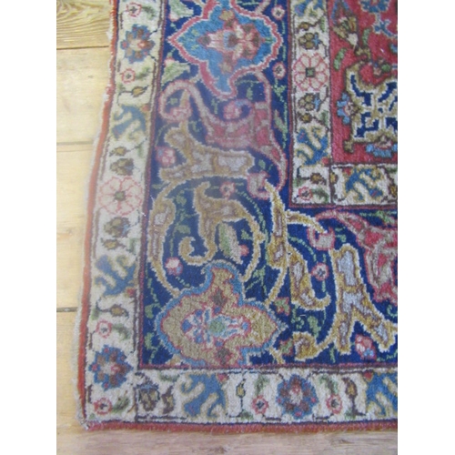 422 - A PERSIAN RUG, early 20th century, the red floral field with central navy blue gul, navy blue main b... 