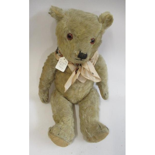 153 - A mid war English teddy bear, with yellow plush, amber glass eyes and cloth pads, 21